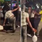 Um grupo de homens brigando em uma calçada no bairro arco-íris de West Hollywood à noite.