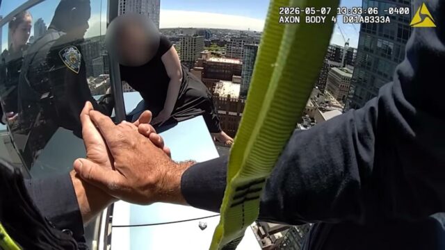 Imagens de roer as unhas mostram uma mulher chorando de Imagens de roer as unhas mostram uma mulher chorando de resgate de policiais da NYPD pendurada na borda de um arranha-céu