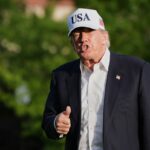 President Donald Trump gestures to reporters as he walks across the South Lawn of the White House, Friday, May 15, 2026, in Washington, on return from Beijing where he met with China's President Xi Jinping.