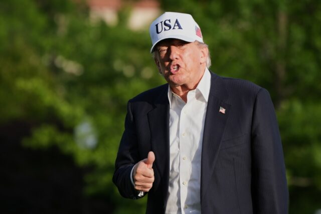 President Donald Trump gestures to reporters as he walks across the South Lawn of the White House, Friday, May 15, 2026, in Washington, on return from Beijing where he met with China's President Xi Jinping.