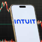 a smartphone displays the logo of Intuit Inc