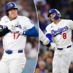 Shohei Ohtani reage ao ser atingido por um arremesso enquanto o árbitro da home plate, Malachi Moore, assiste.