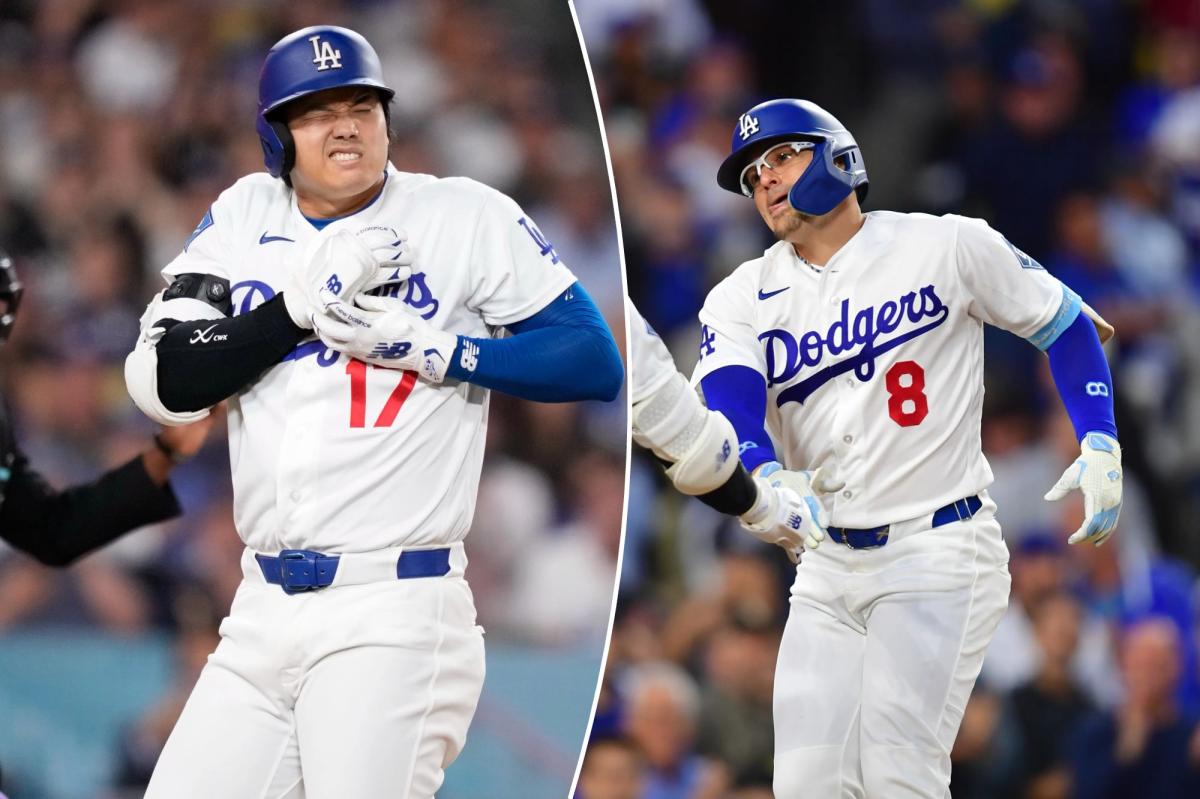 Shohei Ohtani reage ao ser atingido por um arremesso enquanto o árbitro da home plate, Malachi Moore, assiste.