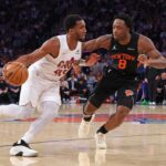 O armador do Cleveland Cavaliers, Donovan Mitchell, dribla contra o atacante do New York Knicks, Og ​​Anunoby.