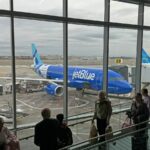 Passengers line up to board a flight at John F. Kennedy International Airport in New York City on November 23, 2024.