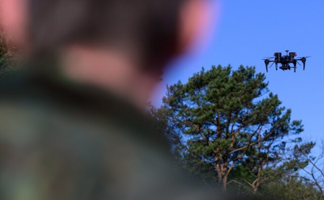 A Bundeswehr soldier observes a drone during a demonstration on April 30 in Lower Saxony, Munster. (Photo by: Philipp Schulze/picture-alliance/dpa/AP Images).