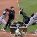Um apanhador do New York Mets tentando marcar um jogador do Detroit Tigers que deslizava para o home plate.