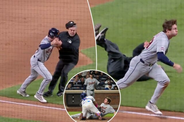 Um apanhador do New York Mets tentando marcar um jogador do Detroit Tigers que deslizava para o home plate.