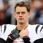 Joe Burrow #9 of the Cincinnati Bengals stands on the sidelines during the national anthem prior to an NFL football game against the Tennessee Titans at Nissan Stadium on December 15, 2024 in Nashville, Tennessee. (Photo by Kevin Sabitus/Getty Images)