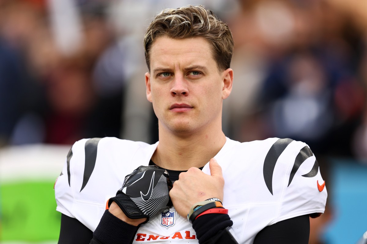 Joe Burrow #9 of the Cincinnati Bengals stands on the sidelines during the national anthem prior to an NFL football game against the Tennessee Titans at Nissan Stadium on December 15, 2024 in Nashville, Tennessee. (Photo by Kevin Sabitus/Getty Images)