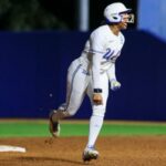 A caloura Jolyna Lamar comemora ao contornar as bases depois de acertar o home run de duas corridas que empatou o jogo na sétima entrada da vitória da UCLA por 12-11 sobre Cal Baptist na abertura do torneio da NCAA em 15 de maio de 2026 em Los Angeles.