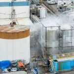 Water is sprayed on a damaged tank at GKN Aerospace in Garden Grove, Calif., on Sunday, May 24, 2026, after the tank containing a chemical used to make plastic parts overheated Thursday.