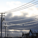 File Photo: A utility pole and power lines heavily encrusted with a thick layer of ice.