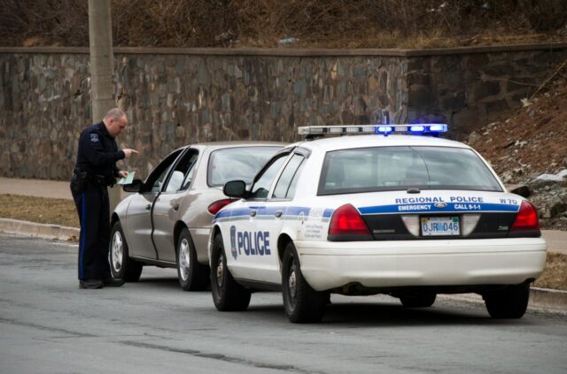 A Halifax police officer gives a motorist a ticket on Dunbrack Street on the side of the road on April 3, 2011, in Nova Scotia, Canada.