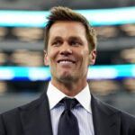 Tom Brady looks on.