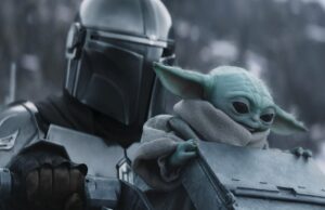‘The Mandalorian and Grogu’: Ludwig Göransson sobre como ‘American Gladiators’ inspirou a cena do Pit Fight e por que o tema ‘Grogu’s World’ se mostrou desafiador STAR WARS: THE MANDALORIAN AND GROGU, from left: Pedro Pascal as The Mandalorian / Din Djarin, Grogu, 2026. © Walt Disney Studios Motion Pictures / Courtesy Everett Collection