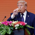 Donald Trump takes a drink during a state banquet hosted by President Xi Jinping at the Great Hall of the People, May 14, 2026, Beijing.