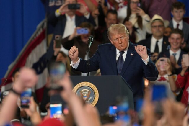Representative Mike Lawler, a New York Republican, shakes hands with Donald Trump as he arrives to speak during a campaign and economic policy event in the Eugene Levy Fieldhouse at SUNY Rockland Community College on May 22 in Suffern, New York. (Roberto Schmidt/Getty Images)