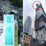 O edifício do Hotel Indigo Hong Kong a partir de uma vista de rua de ângulo baixo, cercado por outros edifícios altos.