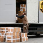 File photo: A UPS worker takes parcels out of a truck.
