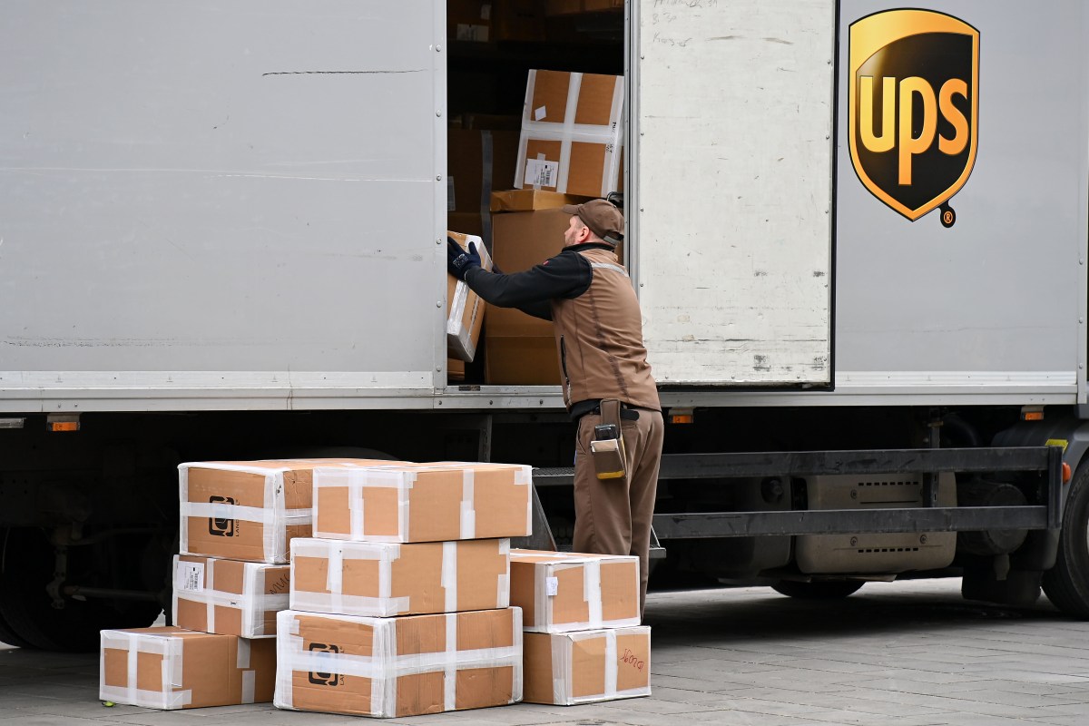 File photo: A UPS worker takes parcels out of a truck.