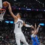 O atacante do San Antonio Spurs, Victor Wembanyama, à direita, bloqueia um chute do centro do Oklahoma City Thunder, Isaiah Hartenstein, durante a segunda metade do jogo 4 nas finais da Conferência Oeste da série de playoffs de basquete da NBA em San Antonio, domingo, 24 de maio de 2026. (AP Photo / Darren Abate)