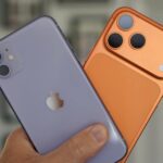 Mascote 3D do Android em uma plataforma gramada com ícones flutuantes para segurança, atualizações e compatibilidade de dispositivos.