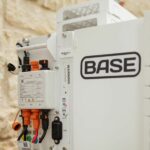 A Base Power battery sits next to a home.