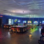 Interior do local de jogos ilegais 999 Arcade em Charlotte, Carolina do Norte, mostrando fileiras de máquinas de jogos, estações de jogos, iluminação neon e áreas de estar durante uma investigação do CMPD sobre operações ilegais de jogos de azar.