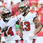TAMPA, FLORIDA - SEPTEMBER 08: Chris Godwin #14 of the Tampa Bay Buccaneers celebrates with Mike Evans #13 after he scored a touchdown in the second quarter of the game against the Washington Commanders at Raymond James Stadium on September 08, 2024 in Tampa, Florida. (Photo by Julio Aguilar/Getty Images)