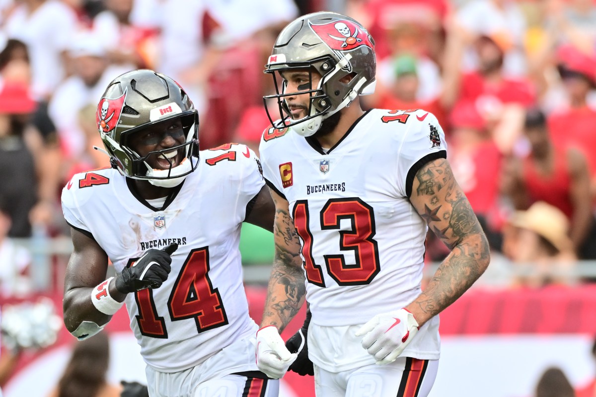 TAMPA, FLORIDA - SEPTEMBER 08: Chris Godwin #14 of the Tampa Bay Buccaneers celebrates with Mike Evans #13 after he scored a touchdown in the second quarter of the game against the Washington Commanders at Raymond James Stadium on September 08, 2024 in Tampa, Florida. (Photo by Julio Aguilar/Getty Images)
