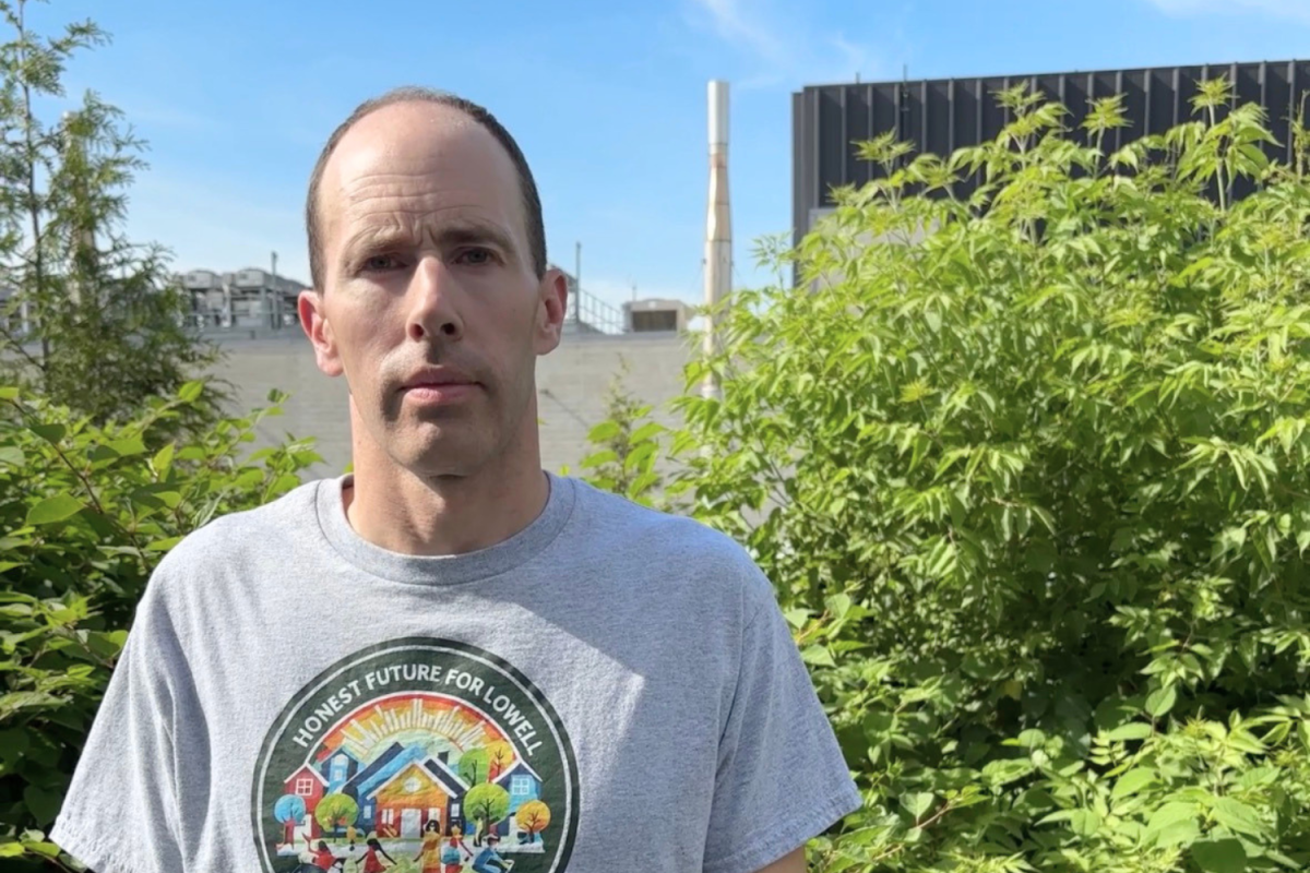Jake Fortes, standing in front of the data center next to his home in Lowell, Massachusetts.