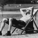 Um londrino é visto tomando sol nos Kensington Gardens, em Londres, em 3 de junho de 1976 - em um verão com ondas de calor que estabeleceu novos recordes na época