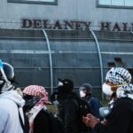 An Immigration and Customs Enforcement agent stands guard ahead of Newark Mayor Ras Baraka's press conference in front of Delaney Hall on June 2, 2026, in Newark, New Jersey. (Michael M. Santiago/Getty Images)