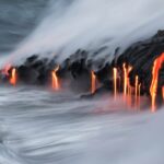 Lava pours into the ocean.