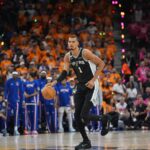 Um torcedor correu para a quadra no meio do quarto período do jogo 1 das finais da NBA no Frost Bank Center, parecendo tentar tirar uma selfie ao lado da estrela de San Antonio, Victor Wembanyama.