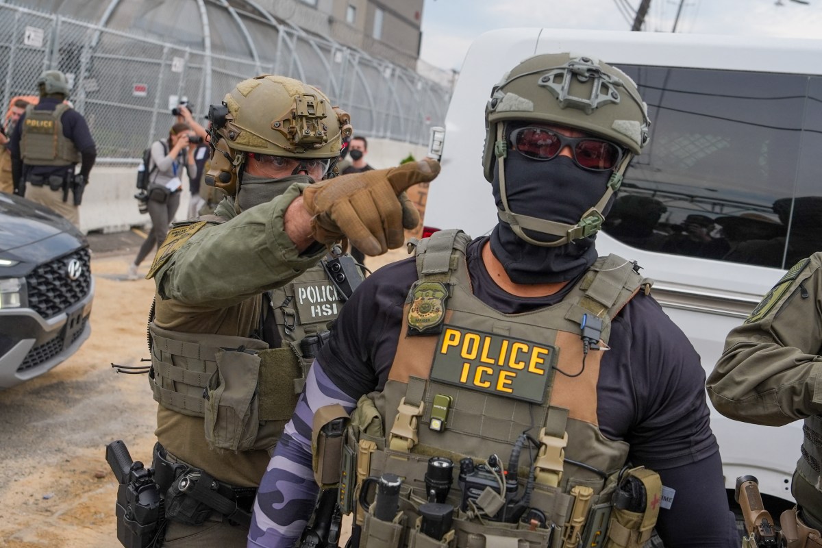 An ICE agent points toward protesters outside the detention center at Delaney Hall, in Newark, New Jersey, June 6, 2026.