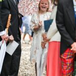 Lena Tindall manteve seu título de realeza mais brincalhona no casamento real de Peter Phillips e Harriet Sperling hoje, enquanto ela brincava alegremente na chuva enquanto segurava um guarda-chuva de unicórnio