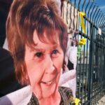 A photograph of Nancy Guthrie is displayed on a banner in front of the KVOA television station on March 1, 2026 in Tucson, Arizona.