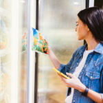 Stock photo: Young brunette woman buying fresh frozen food in the store.