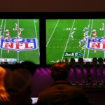 Bar patrons watch the YouTube TV telecast of the game between the Kansas City Chiefs and the Los Angeles Chargers on September 5, 2025, in Buffalo, New York.