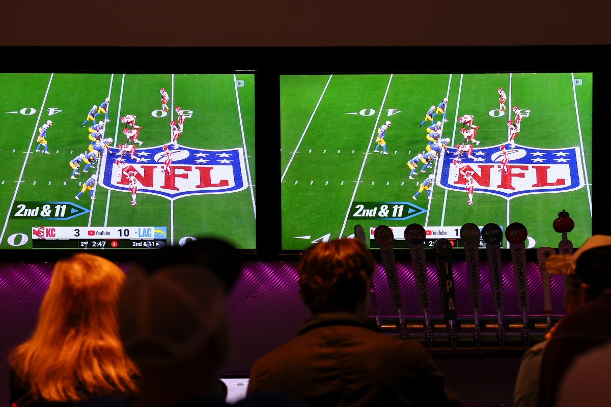 Bar patrons watch the YouTube TV telecast of the game between the Kansas City Chiefs and the Los Angeles Chargers on September 5, 2025, in Buffalo, New York.