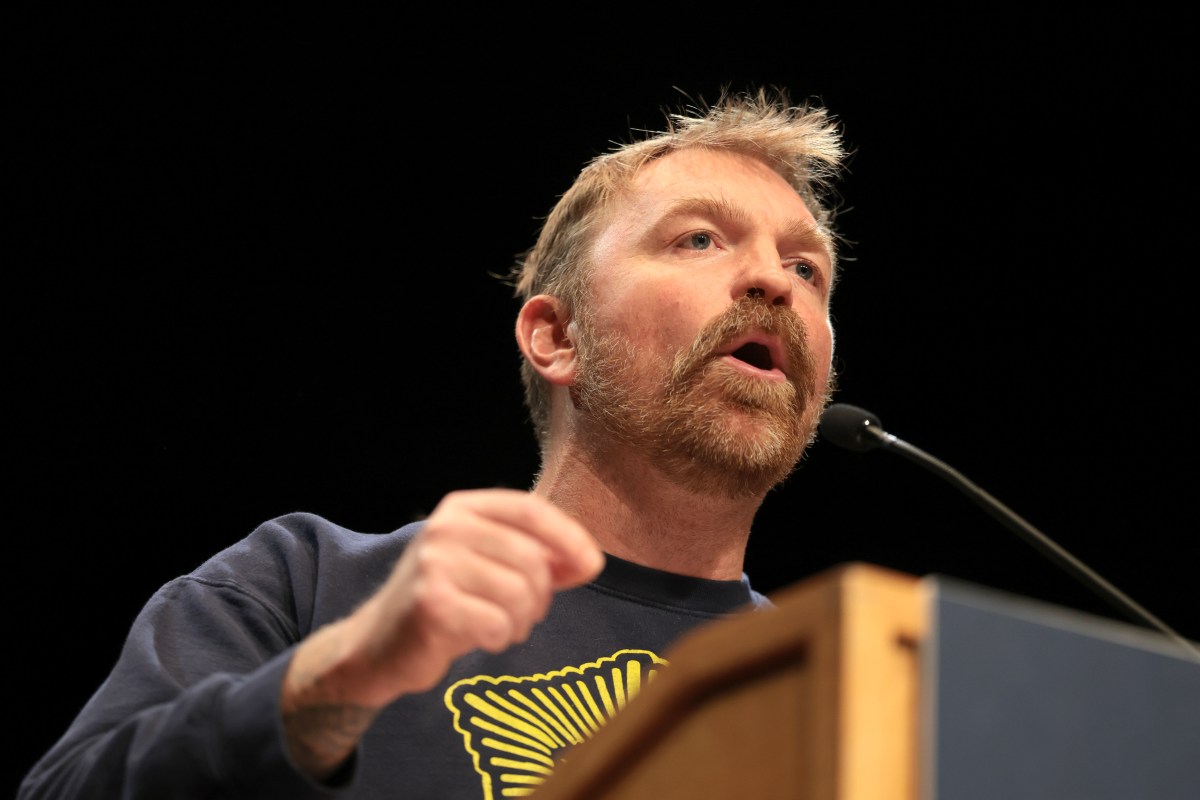 Democratic U.S. Senate candidate Graham Platner speaks at a “Fighting Oligarchy” tour stop held by Senator Bernie Sanders at the Collins Center for the Arts on the University of Maine campus on May 24 in Orono, Maine. (Photo by Joe Raedle/Getty Images)