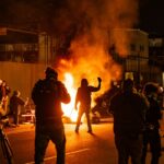 Anti-ICE protesters light a fire outside the Delaney Hall detention center in New Jersey in May.