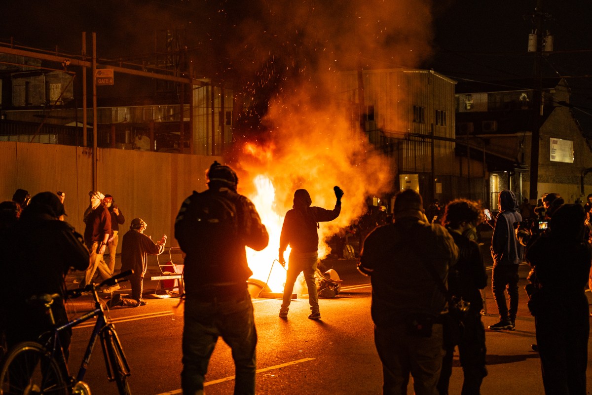 Anti-ICE protesters light a fire outside the Delaney Hall detention center in New Jersey in May.