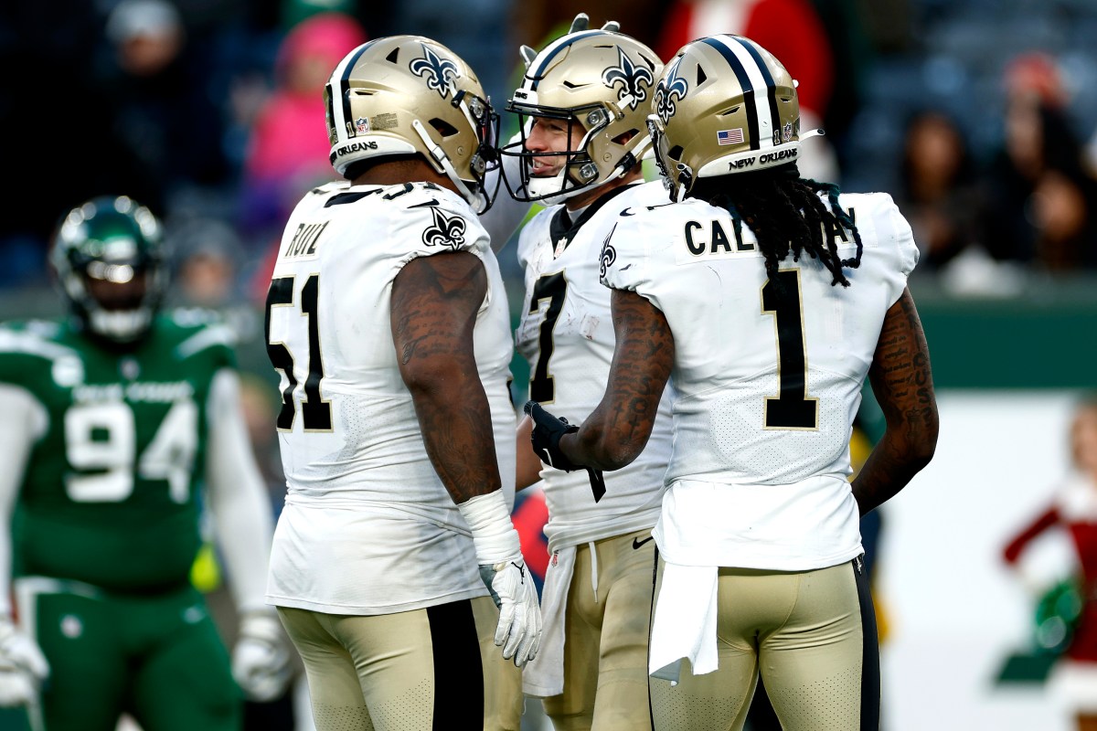 EAST RUTHERFORD, NEW JERSEY - DECEMBER 12: Cesar Ruiz #51 and Marquez Callaway #1 of the New Orleans Saints congratulate teammate Taysom Hill #7 after Hill scored on a 44-yard rushing touchdown against the New York Jets during the fourth quarter at MetLife Stadium on December 12, 2021 in East Rutherford, New Jersey. (Photo by Sarah Stier/Getty Images)