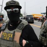 Immigration and Customs Enforcement agents stand guard outside Delaney Hall immigration detention center in New Jersey in May.