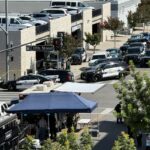 Multiple police vehicles are stationed outside the bank in Bakersfield, California.