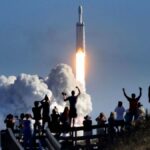 The crowd cheers at Playalinda Beach in the Canaveral National Seashore, just north of the Kennedy Space Center, during the launch of the SpaceX Falcon Heavy rocket, on Feb. 6, 2018. Playalinda is one of closest public viewing spots to see the launch, about 3 miles from the SpaceX launchpad 39-A. (Joe Burbank/Orlando Sentinel/Tribune News Service via Getty Images)