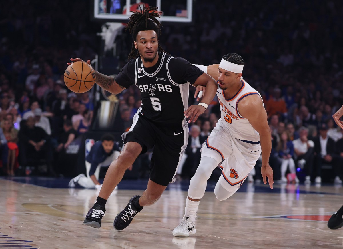 San Antonio Spurs guard Stephon Castle drives past New York Knicks star Josh Hart in NBA Finals game